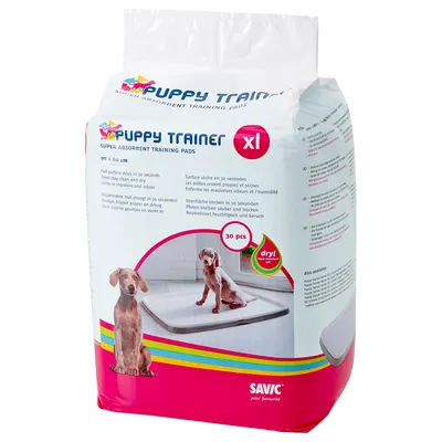 Puppy Trainer XL -koulutusalustat, 90 x 60 cm, 30 kpl. Pakkauksessa koiranpentu alustalla. Brändi: Savic. Teksti englanniksi: super absorbent training pads, dry! in 30 seconds.