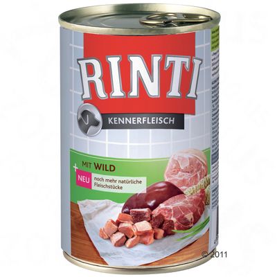 Lata de comida para perros Rinti Kennerfleisch. Texto visible: 'Mit Wild', 'neu noch mehr natürliche Fleischstücke'. Imagen de trozos de carne y órganos en la etiqueta.