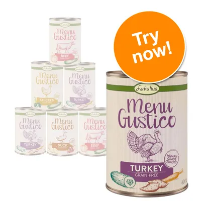 Lukullus Menu Gustico tins: beef, chicken, turkey, duck. Large tin in front labelled Turkey Grain-Free, 400g, human-grade quality. Orange badge reads Try now!