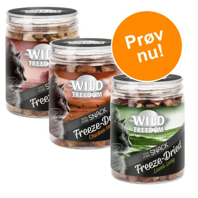 Tre bøtter Wild Freedom 100% Pure Snack Freeze-Dried til kat, varianter Chicken Heart og Lamb Lung. Orange cirkel med teksten 'Prøv nu!'.