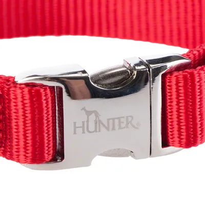 Rødt hundehalsbånd med sølvfarvet metalspænde, indgraveret Hunter-logo og slidstærkt nylonmateriale.