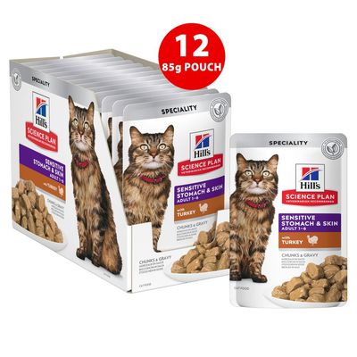 Box of 12 pouches, each 85g, labelled 'Sensitive Stomach & Skin Adult 1-6 with Turkey, Chunks & Gravy'. Product packaging and portion size visible.