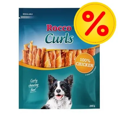 Rocco Curls hundgodis, 100 % chicken, förpackning med bild på hund och texten 'Curly chewing fun!', vikt 200 g. Procent-symbol visar erbjudande.