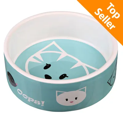 Ciotola in ceramica azzurra con disegni di gatti stilizzati e scritta 'Oops!', etichetta arancione con testo 'Top Seller' nell'angolo superiore destro.