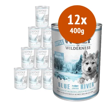 Confezione da 12 lattine da 400 g di Little Wolf of Wilderness Blue River Junior, 100% grain-free, visibile etichetta con immagine di lupo e fiume blu.