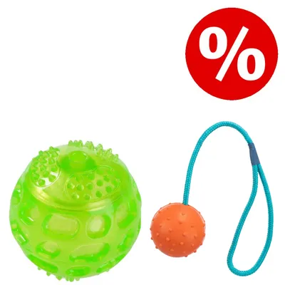 Grüner Noppenball und orangefarbener Ball mit blauer Schnur, daneben rotes Prozentzeichen für Rabattaktion.