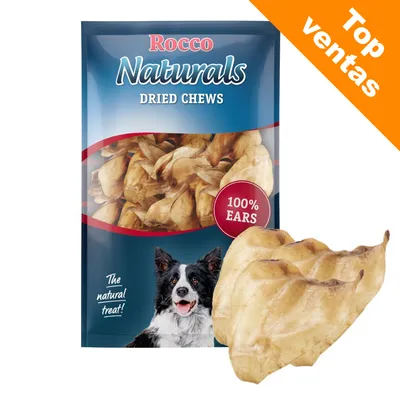 Rocco Naturals Dried Chews, 100% Ears. Paquete con golosinas secas para perros. Etiqueta naranja: Top ventas. Imagen de un perro en el envase.