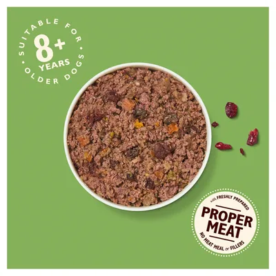 Bowl of minced dog food on green background. Text: Suitable for 8+ years older dogs. Proper Meat, with freshly prepared, no meat meal or fillers.