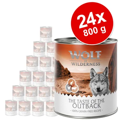 Set 24x800 g conserve Wolf of Wilderness The Taste of the Outback, 100% grain-free recipe. Ambalaj cu imagine de peisaj și text vizibil pe etichetă.