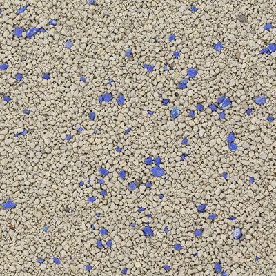 Close-up van kattenbakvulling met grijze korrels en blauwe deeltjes.