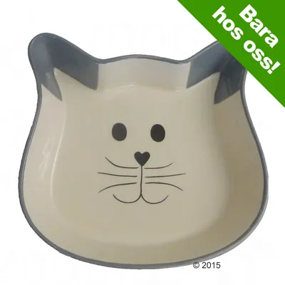 Kattformad matskål i keramik med kattansikte, grå och beige. Grön text i hörnet: Bara hos oss! © 2015.
