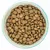 Bowl filled with round, brown dry pet food kibble pieces shown from above to display shape and texture.