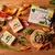 Forthglade puppy food variety pack with visible ingredients including sweet potato, peas, carrots and herbs. Packaging highlights grain free, complete meal, 75% lamb or chicken.