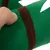 Gros plan sur une main tenant un objet en feutre vert avec bande marron, matière textile visible.