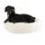 Petit chien noir allongé sur un coussin rond blanc en tissu peluche, fond blanc. Aucun texte ou marque visible.