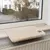 Beige windowsill pad with soft surface and brown paw motif, placed on a windowsill above a radiator.