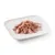 Close-up of tender meat strips in jelly on a white plate, shown as a product example for pet food.