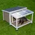 Niche en bois avec toit incliné, partie avant couverte en plastique transparent, chien noir allongé à l’intérieur, posée sur pelouse verte. Matériaux visibles : bois, plastique. Niche en bois avec toit incliné, partie avant couverte en plastique transparent, chien noir allongé à l’intérieur, posée sur pelouse verte. Matériaux visibles : bois, plastique.