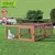 Natura Outdoor Qualität wooden enclosure with mesh walls, weatherproof and easy to assemble. Shown with water bottle and rabbit on green grass.