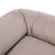 Gros plan sur un coin de coussin ou panier pour animal en tissu beige, texture douce et rembourrée visible.