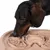 Dog eating from a beige anti-gulping bowl with labyrinth design that promotes slow eating.