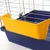 Yellow plastic feeding bowl attachment, fixed to a blue cage with metal grid.