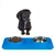 Dachshund in front of a blue feeding station with two stainless steel bowls, one filled with dry food and the other empty.