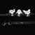 Cinta negra con tres clips blancos en forma de animales: caracol, pez y mariposa. Gancho metálico visible al final de la cinta.