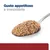 Gusto appetitoso e irresistibile. Cibo umido marrone su un cucchiaio, testo visibile: Gusto appetitoso e irresistibile.