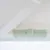 Detailní pohled na zelený posuvný přepínač s nápisy 'LOCK' a 'UNLOCK' pro zamčení nebo odemčení.