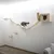 Wall-mounted climbing and play system made of wood with bridge, platforms and cave. Two cats demonstrate use of the system.