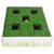 Toy box with green lawn design, five openings, and yellow ball visible in one of the openings.