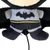 Plush toy in Batman design with black bat symbol on grey background and yellow belt.