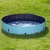 Piscina redonda plegable de plástico azul claro y negro, llena de agua, colocada sobre césped. Visible válvula de drenaje en la parte inferior.