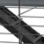 Close-up of a metal cage with hook lock and black plastic tray in the background.