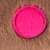 Close-up of brown fur material with a round pink patch in the centre.