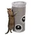 Cat using a tall, cylindrical scratching post with two circular openings and hanging plush balls inside for play.