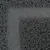 Nahaufnahme einer grauen, strukturierten Oberfläche mit verschlungenen Fasern. Materialdetails sichtbar.