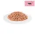 Portion of wet food with beef on a white plate, cow symbol in a pink corner.