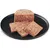 Slices of wet food on a black plate, showing the texture and composition of the food.