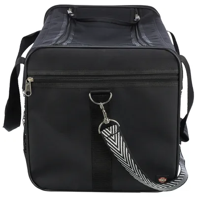 Sac de transport noir en tissu avec bandoulière à motif zigzag, fermeture éclair et logo Trixie visible en bas à droite.