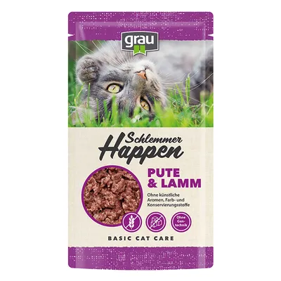 Opakowanie grau Schlemmer Happen Pute & Lamm, widoczny fragment karmy, napisy: Ohne künstliche Aromen, Farb- und Konservierungsstoffe, Ohne Gentechnik, Basic Cat Care.