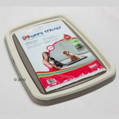 Podkładka treningowa dla szczeniąt Savic Puppy Trainer, opakowanie z widoczną nazwą produktu i zdjęciem psa na podkładce oraz osoby trzymającej szczeniaka.