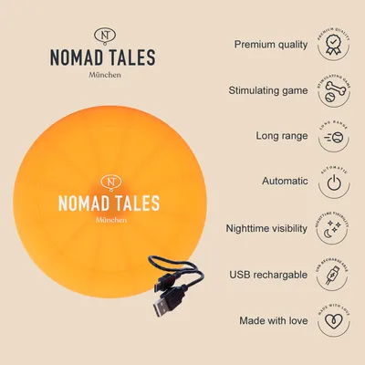 Nomad Tales München. Orange disc with USB cable. Features: premium quality, stimulating play, long range, automatic, night visibility, USB rechargeable, made with love.