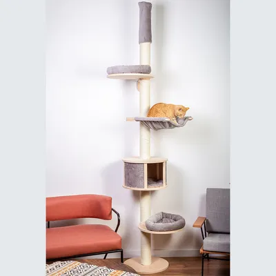 Tall scratching post with multiple levels, including a cave and grey fabric resting areas. An orange cat is lying on one of the platforms.