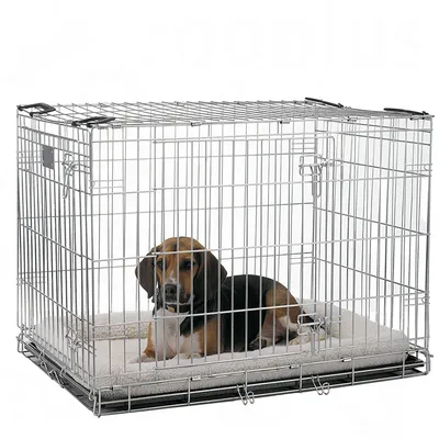 Wire pet crate with a cushioned mat inside, shown in use by an animal lying down to demonstrate size and comfort.
