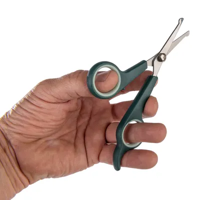 Hand holding a green pair of scissors with rounded tips and ergonomic handles, suitable for precise cutting.