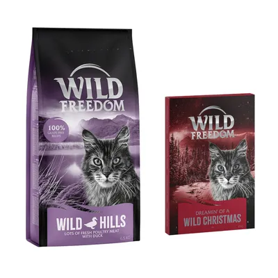 Balení Wild Freedom Wild Hills 6,5 kg s textem '100% grain-free recipe' a krabice Wild Freedom Dreamin' of a Wild Christmas 180 g. Na obou je vyobrazená kočka.