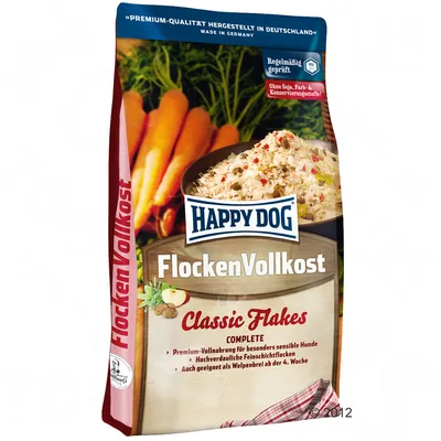 Happy Dog FlockenVollkost Classic Flakes, envase con imagen de copos y zanahorias. Texto visible: sin soja, colorantes ni conservantes. Fabricado en Alemania.