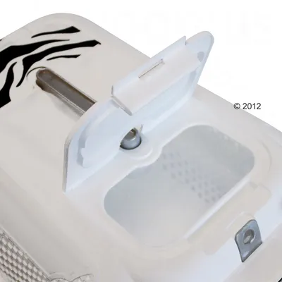 Detail van een wit kunststof deksel met open klep en transparant venster, metalen sluiting en zwart zebrapatroon. © 2012 zichtbaar op het oppervlak.